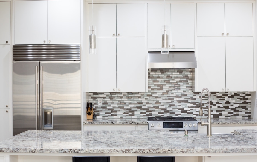 Snapshot of interior modern kitchen with granite countertop island and smart refrigerator